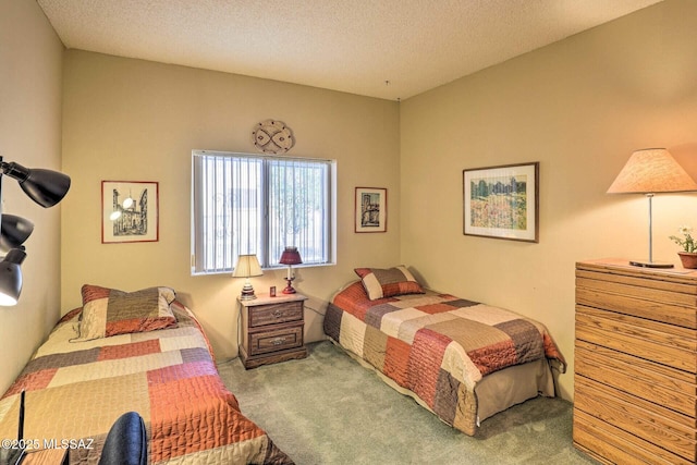 carpeted bedroom featuring a textured ceiling