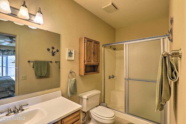 bathroom featuring vanity, a stall shower, connected bathroom, and toilet