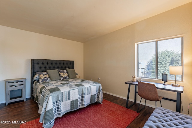 bedroom with dark hardwood / wood-style floors