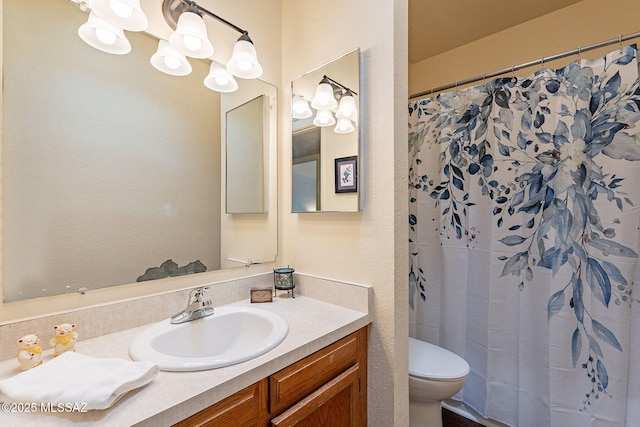 bathroom with vanity, a notable chandelier, toilet, and walk in shower