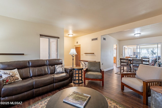 living room with dark hardwood / wood-style flooring