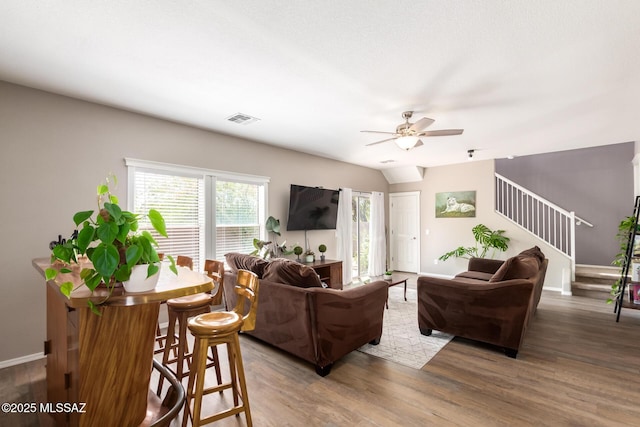 living room with dark hardwood / wood-style floors and ceiling fan