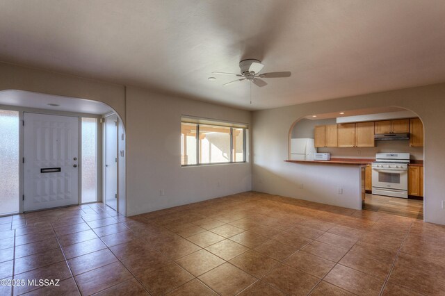 empty room with light tile patterned floors and ceiling fan