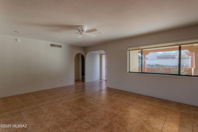 empty room featuring tile patterned flooring and ceiling fan