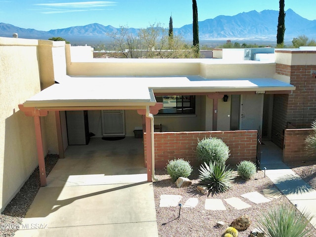 view of front facade featuring a mountain view and a carport