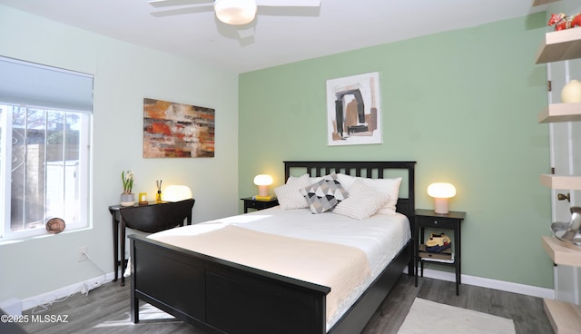 bedroom with dark hardwood / wood-style floors and ceiling fan