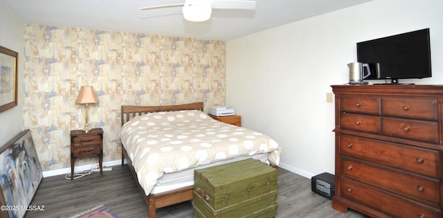 bedroom with ceiling fan and dark hardwood / wood-style flooring