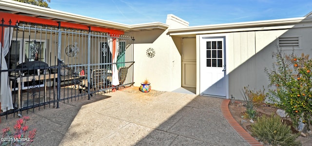 doorway to property featuring a patio area