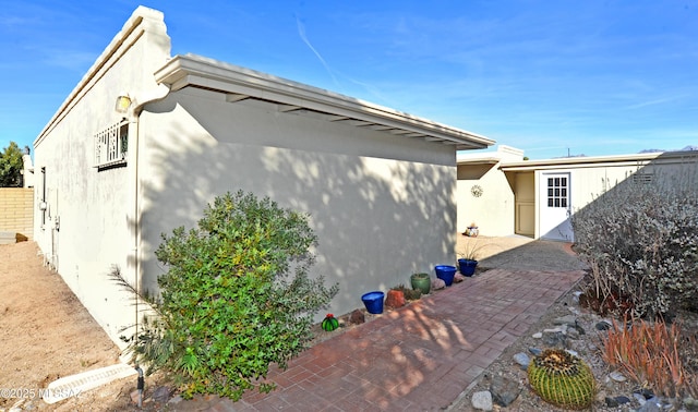 view of side of property with a patio area