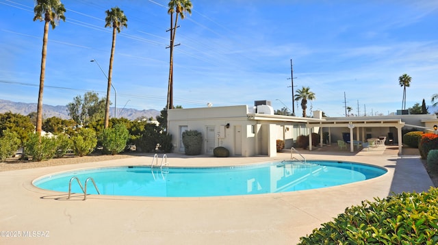 view of pool featuring a patio and a mountain view