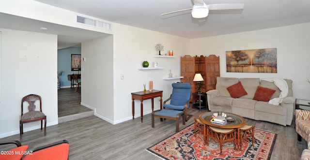 living room with hardwood / wood-style flooring and ceiling fan