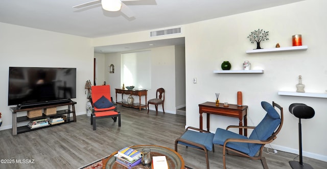 living room with ceiling fan and wood-type flooring