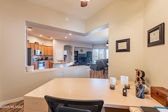 dining area with hardwood / wood-style flooring and ceiling fan