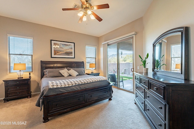 carpeted bedroom featuring multiple windows, access to exterior, and ceiling fan