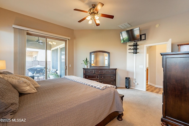 bedroom featuring access to outside, light colored carpet, and ceiling fan