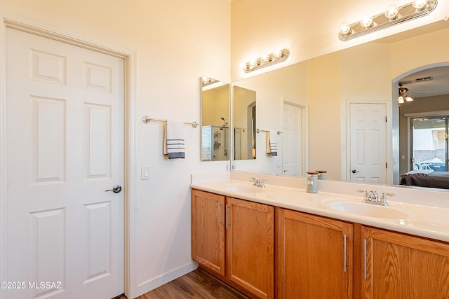 bathroom with hardwood / wood-style flooring, ceiling fan, and vanity