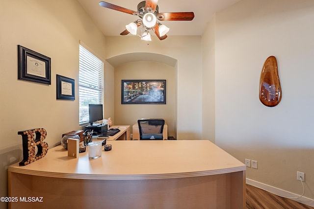 home office featuring ceiling fan and dark wood-type flooring