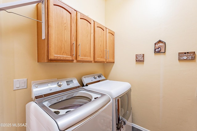 laundry area with cabinets and washing machine and clothes dryer