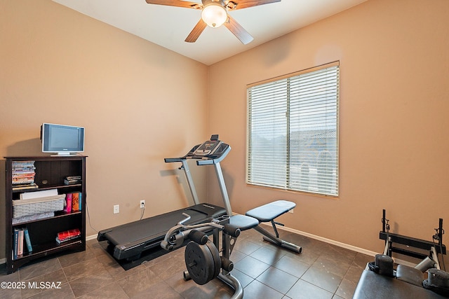 exercise room featuring ceiling fan and dark tile patterned flooring