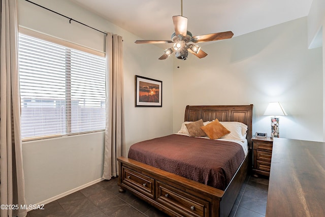 tiled bedroom featuring ceiling fan