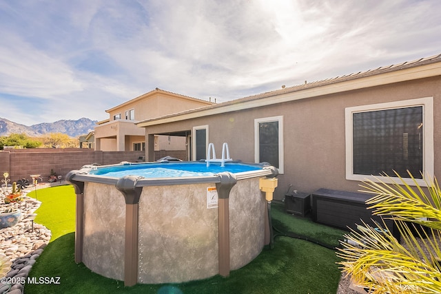 exterior space with a mountain view and a fenced in pool