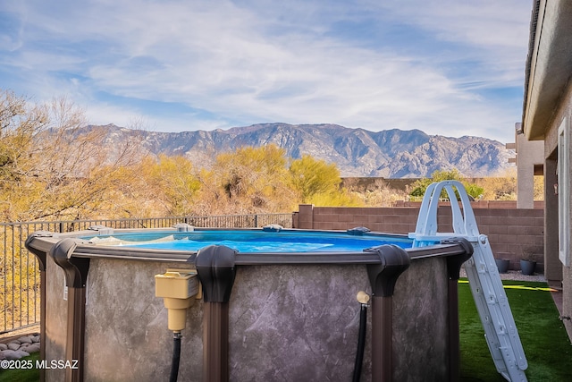 exterior space featuring a mountain view and a fenced in pool