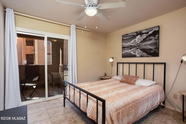 tiled bedroom with ceiling fan, access to exterior, and a textured ceiling