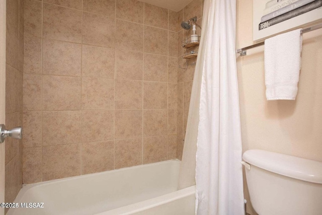 bathroom featuring toilet and shower / bath combo with shower curtain