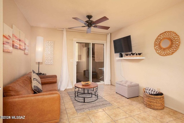 tiled living room with ceiling fan