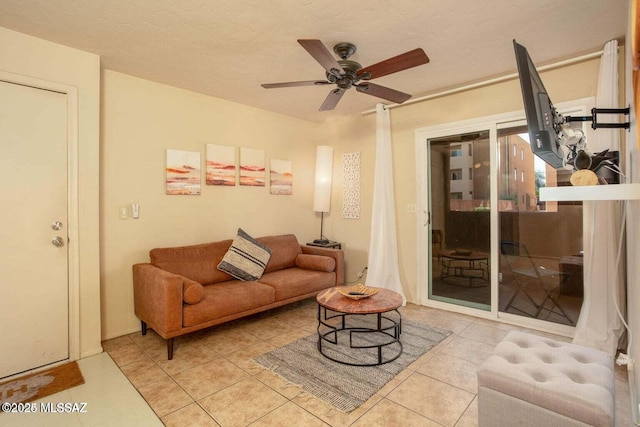 tiled living room with ceiling fan and a textured ceiling