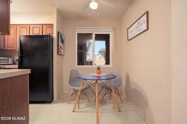 kitchen featuring black refrigerator and ceiling fan