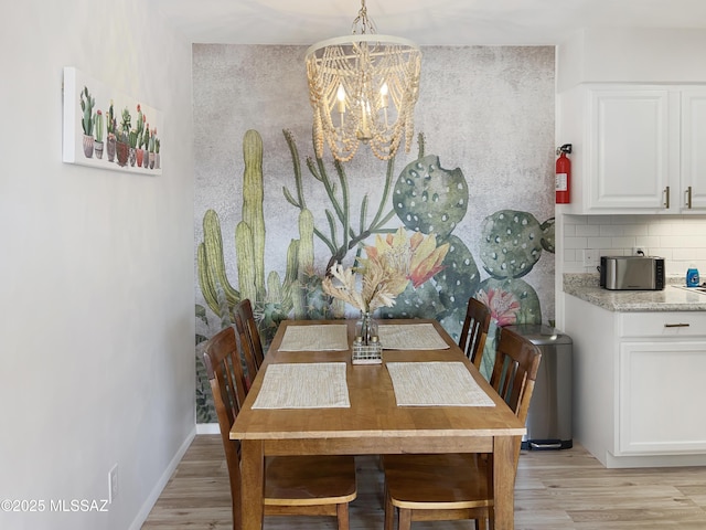 dining room featuring a chandelier and light hardwood / wood-style flooring