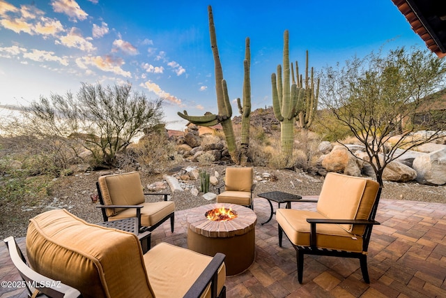 view of patio featuring an outdoor living space with a fire pit