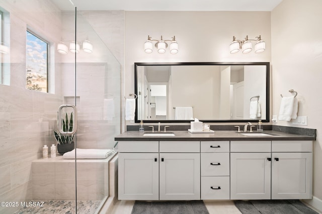 bathroom with vanity and tiled shower