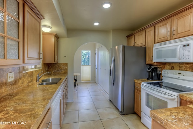 kitchen with white appliances, sink, decorative backsplash, and light tile patterned floors