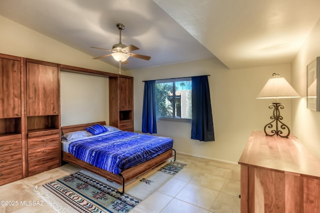 tiled bedroom with lofted ceiling and ceiling fan