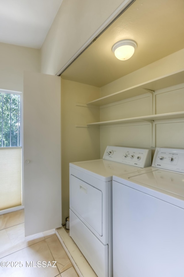 washroom with washer and dryer and light tile patterned floors