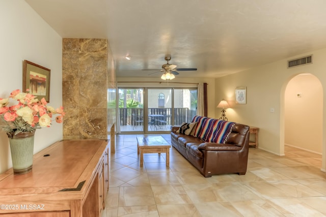 tiled living room featuring ceiling fan