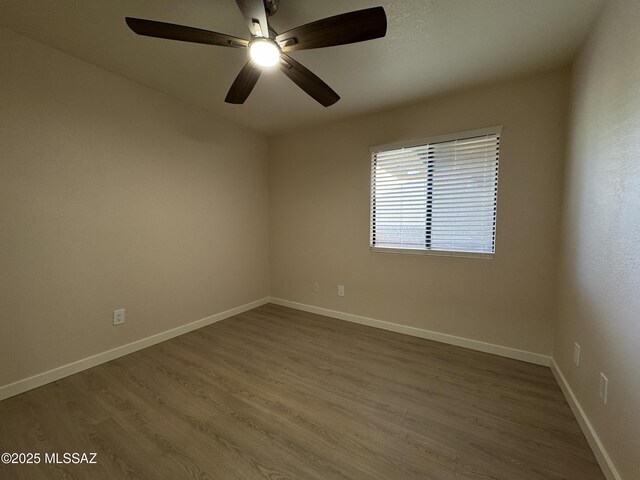 unfurnished living room featuring a tile fireplace, ceiling fan, and light wood-type flooring