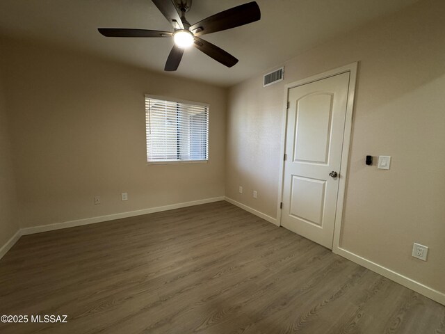 kitchen featuring gray cabinets, light hardwood / wood-style flooring, and range with electric stovetop