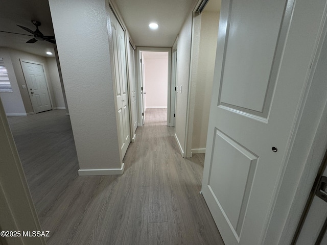 corridor with light hardwood / wood-style flooring