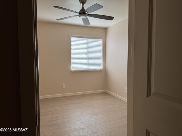 empty room featuring ceiling fan and light wood-type flooring