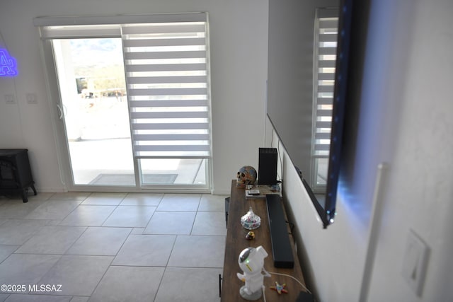 doorway to outside with light tile patterned floors