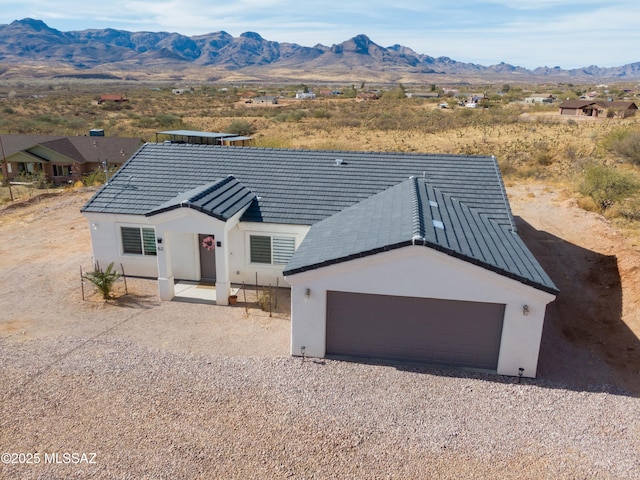 view of front of property featuring a garage and a mountain view