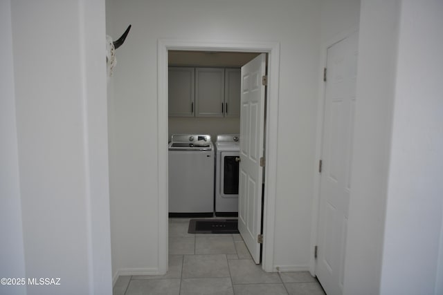 corridor featuring light tile patterned flooring and washer and clothes dryer