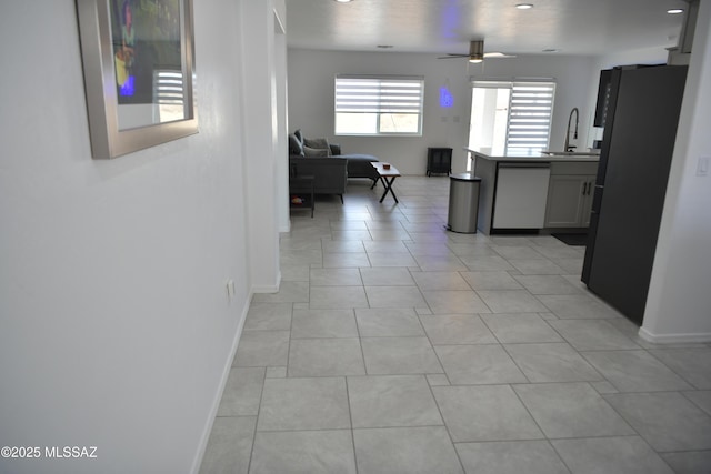 hall with light tile patterned flooring and sink