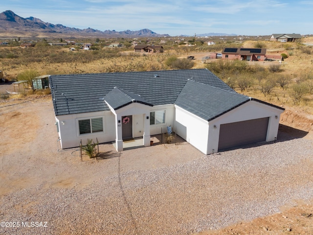 view of front of home with a garage and a mountain view