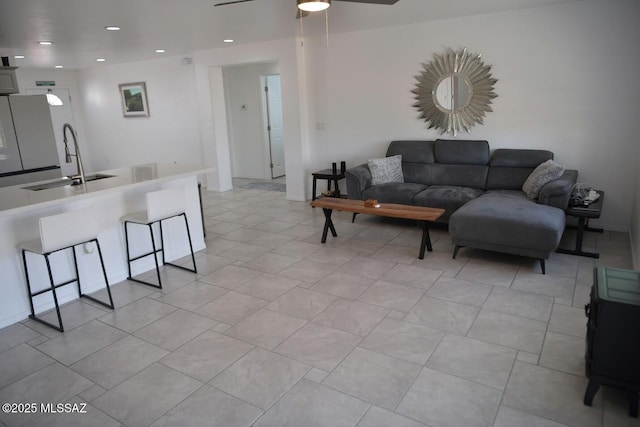 living room with sink and ceiling fan