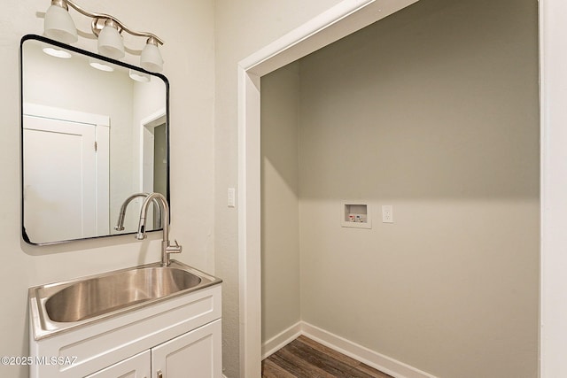 laundry room featuring washer hookup, sink, and dark hardwood / wood-style floors