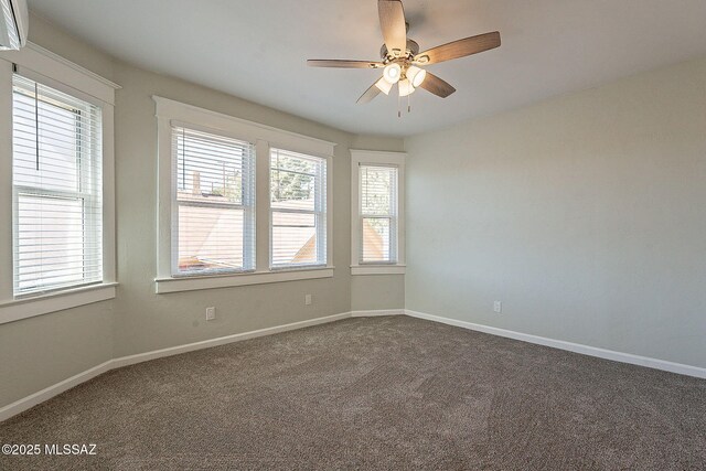 spare room with ceiling fan and carpet